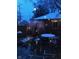 Snowy backyard patio with outdoor dining set and string lights for charming outdoor living at 5157 N New Jersey St, Indianapolis, IN 46205