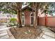 Landscaped backyard featuring a brick structure, trees, and decorative elements for tranquil outdoor space at 5157 N New Jersey St, Indianapolis, IN 46205