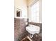 Charming bathroom with unique tile, a classic sink, and a bright window at 5157 N New Jersey St, Indianapolis, IN 46205