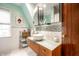 Well-lit bathroom featuring a modern vanity, decorative mirror, and stylish faucet at 5157 N New Jersey St, Indianapolis, IN 46205