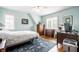 Well-lit bedroom with hardwood floors, neutral walls, and traditional wood furniture at 5157 N New Jersey St, Indianapolis, IN 46205