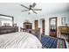 Bright bedroom featuring a ceiling fan, hardwood floors, and dark wood furniture at 5157 N New Jersey St, Indianapolis, IN 46205