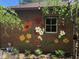 A brick exterior features a beautiful painted flower mural, a garden area, and outdoor furniture at 5157 N New Jersey St, Indianapolis, IN 46205