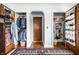 Hallway closet featuring built-in shelves and space saving shoe organizers at 5157 N New Jersey St, Indianapolis, IN 46205
