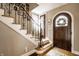 Inviting entryway with hardwood floors, staircase, and decorative front door with wreath at 5157 N New Jersey St, Indianapolis, IN 46205