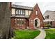 Beautiful brick Tudor home featuring a unique front facade and inviting landscaping at 5157 N New Jersey St, Indianapolis, IN 46205
