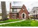 Charming brick Tudor home with a manicured lawn and walkway to the front door at 5157 N New Jersey St, Indianapolis, IN 46205