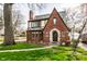 Charming brick Tudor home with a manicured lawn and walkway to the front door at 5157 N New Jersey St, Indianapolis, IN 46205