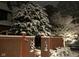 Snowy evergreens decorate the facade of this gorgeous home behind a snowy gate at 5157 N New Jersey St, Indianapolis, IN 46205