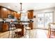 Well-lit kitchen with dark countertops, wooden cabinets, and a central island with seating at 5157 N New Jersey St, Indianapolis, IN 46205
