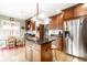 Bright kitchen with wooden cabinetry, stainless steel refrigerator, and a kitchen island at 5157 N New Jersey St, Indianapolis, IN 46205