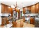 Spacious kitchen with stainless steel appliances, wood cabinets, and a center island at 5157 N New Jersey St, Indianapolis, IN 46205
