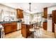 Open kitchen featuring hardwood floors, wooden cabinets, and stainless steel appliances at 5157 N New Jersey St, Indianapolis, IN 46205