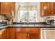 Close-up of a kitchen sink area with modern appliances and a view from the window at 5157 N New Jersey St, Indianapolis, IN 46205