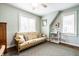 Comfortable room featuring a futon, natural lighting, and hardwood floors at 5157 N New Jersey St, Indianapolis, IN 46205