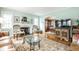 Cozy living room with a fireplace, arched doorway, hardwood floors, and comfortable armchairs at 5157 N New Jersey St, Indianapolis, IN 46205