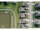 Aerial view of homes with well-maintained lawns, a pond, and access to walking trails in a desirable community at 5178 Aegis Dr, Noblesville, IN 46062