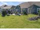 Large backyard with a stone patio, dining set, and a well-maintained lawn providing great outdoor space at 5178 Aegis Dr, Noblesville, IN 46062