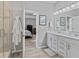 Bright bathroom featuring a double sink vanity, shower, and an open doorway to the Primary bedroom at 5178 Aegis Dr, Noblesville, IN 46062