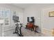 Bright workout room with a stationary bike next to the shuttered windows and television at 5178 Aegis Dr, Noblesville, IN 46062