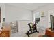 Neutral bedroom with a functional workout area featuring a stationary bike and TV at 5178 Aegis Dr, Noblesville, IN 46062