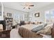 Bright bedroom featuring a bed, home office area, and natural lighting from the windows at 5178 Aegis Dr, Noblesville, IN 46062