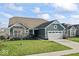 Inviting single-Gathering home with a manicured lawn, attached two-car garage, and complemented by mature landscaping at 5178 Aegis Dr, Noblesville, IN 46062