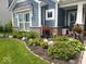 Charming front yard features colorful flower arrangements and lush landscaping, boosting curb appeal for this inviting home at 5178 Aegis Dr, Noblesville, IN 46062