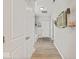 Inviting hallway with white trim, light wood floors, and elegant decor at 5178 Aegis Dr, Noblesville, IN 46062