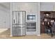 Stainless steel fridge and appliances in the kitchen complemented by a desk space at 5178 Aegis Dr, Noblesville, IN 46062