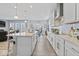 Open-concept kitchen with a large island, stainless steel appliances, seamlessly connecting to the dining and living areas at 5178 Aegis Dr, Noblesville, IN 46062