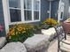 Beautiful landscaping design featuring thriving plants and decorative stone edging around the home's foundation at 5178 Aegis Dr, Noblesville, IN 46062
