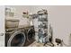 Functional laundry room with modern washer and dryer, shelving, and storage at 5178 Aegis Dr, Noblesville, IN 46062