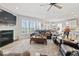 Bright living room with fireplace, large windows with shutters, and comfortable seating at 5178 Aegis Dr, Noblesville, IN 46062