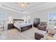 Spacious main bedroom with a ceiling fan, tray ceiling, and plenty of natural light at 5178 Aegis Dr, Noblesville, IN 46062