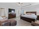 Main bedroom with ceiling fan, tray ceiling, and ample closet space, providing a luxurious retreat at 5178 Aegis Dr, Noblesville, IN 46062