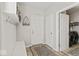 Clean mud room with coat hooks, bench, and access to the laundry room at 5178 Aegis Dr, Noblesville, IN 46062
