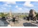 Stone patio with fireplace, string lights, and lake views creating a cozy atmosphere for outdoor gatherings at 5178 Aegis Dr, Noblesville, IN 46062