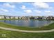 Picturesque view of a community pond with a fountain and well-maintained landscaping creating a serene atmosphere at 5178 Aegis Dr, Noblesville, IN 46062