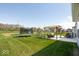 Lush backyard with a trampoline, play set, pergola, and pond at 5300 Veranda Dr, Noblesville, IN 46062