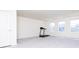 Spacious room with a treadmill, large windows, and a neutral carpet at 5300 Veranda Dr, Noblesville, IN 46062