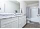 Bright bathroom with double vanity, granite countertop, mirror, and shower-tub combination at 5300 Veranda Dr, Noblesville, IN 46062