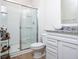 Modern bathroom with a glass shower, vanity with sink, granite countertop and wood floor at 5300 Veranda Dr, Noblesville, IN 46062