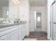 Well-lit bathroom featuring dual access points, stone countertops, and a glass-enclosed shower at 5300 Veranda Dr, Noblesville, IN 46062