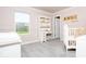A pink Bedroom with a large window and a crib at 5300 Veranda Dr, Noblesville, IN 46062