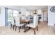 Open dining area with a wooden table, seating for six, modern lighting, and access to the backyard at 5300 Veranda Dr, Noblesville, IN 46062