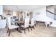 Open dining area adjacent to a kitchen featuring a large table, seating for six, and hardwood floors at 5300 Veranda Dr, Noblesville, IN 46062