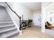 Bright entryway featuring hardwood floors, staircase, and decorative bicycle accent, creating a welcoming first impression at 5300 Veranda Dr, Noblesville, IN 46062