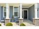 Inviting front porch with seating area, complemented by brick accents and providing a welcoming entrance to the home at 5300 Veranda Dr, Noblesville, IN 46062