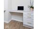 Home office with white built-in desk and cabinets, modern hardware, and hardwood flooring at 5300 Veranda Dr, Noblesville, IN 46062